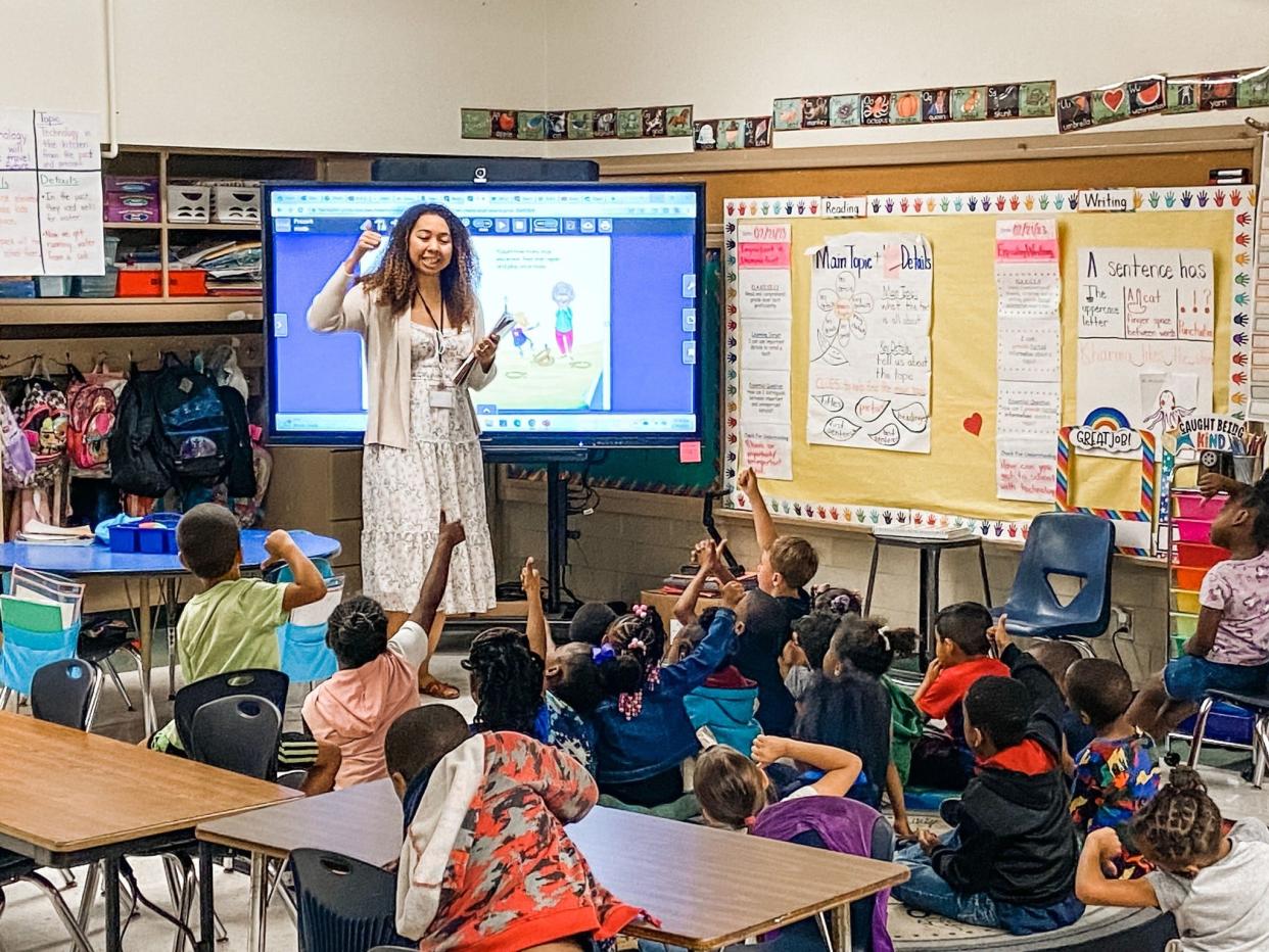 Liza McGlockton, Teach For America corps member teacher at Hyde Grove Early Learning Center, helps her students start the day with an energizing and motivating song.