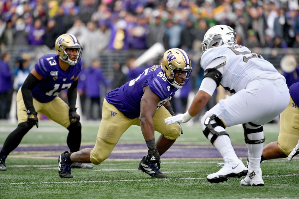 Levi Onwuzurike (center) of the Washington Huskies gets off the ball during the game against the Oregon Ducks at Husky Stadium on Oct. 19, 2019 in Seattle.