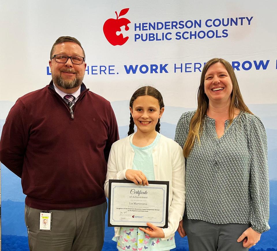 Bruce Drysdale Elementary fifth-grade student Lia Martinonis was honored with a Certificate of Achievement by the Henderson County School Board for her Daughters of the American Revolution award-winning essay. Shown with Lia are Jason Joyce, Bruce Drysdale principal, left, and Lia's teacher, April Summey at right.