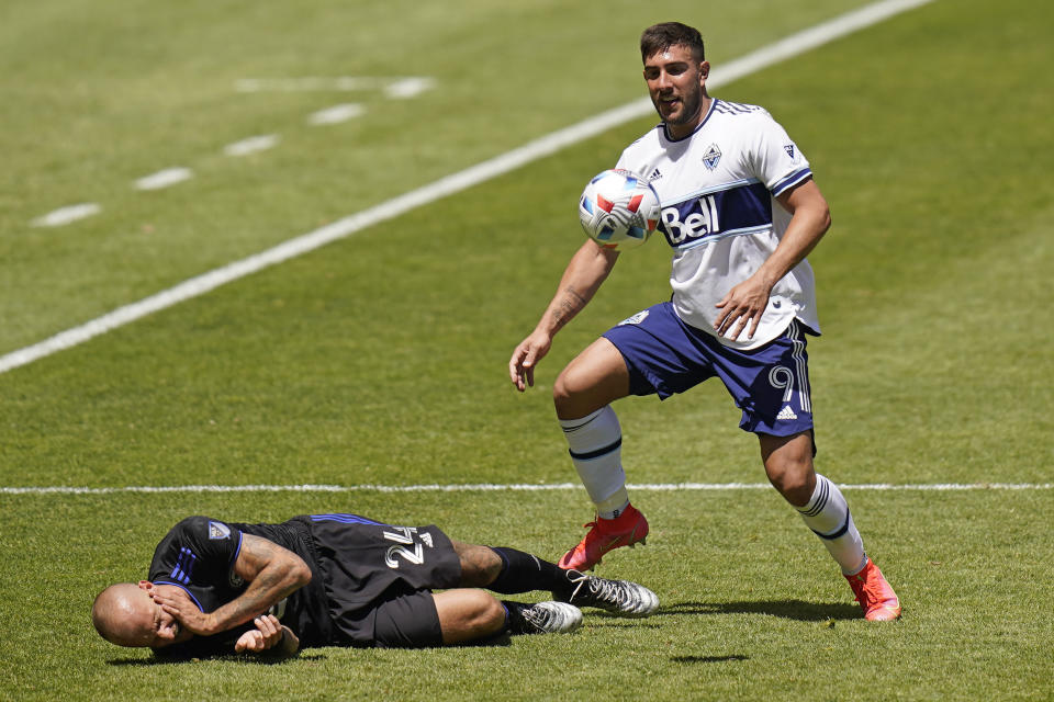 Vancouver Whitecaps forward Lucas Cavallini (9) fouls CF Montréal defender Aljaz Struna (24) in the first half during an MLS soccer game Saturday, May 8, 2021, in Sandy, Utah. (AP Photo/Rick Bowmer)