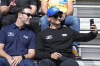 Alex Palou, right, of Spain, takes a photo with Jimmie Johnson during the drivers meeting for the Indianapolis 500 auto race at Indianapolis Motor Speedway, Saturday, May 28, 2022, in Indianapolis. (AP Photo/Darron Cummings)