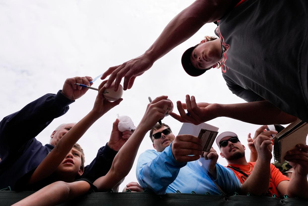 Jackson Holliday signs autographs for fans during spring training in Sarasota.