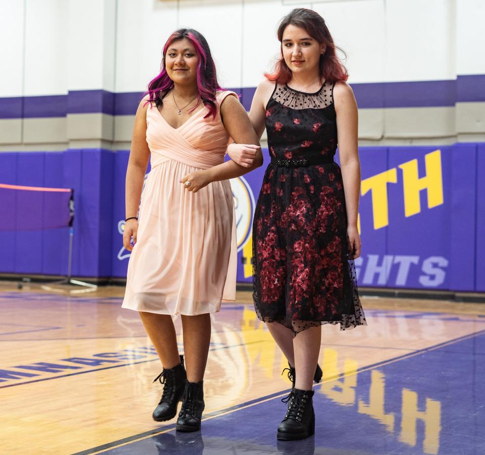 Students at North Henderson High School model prom attire during the 2022 North Gilded Knight Fashion Show.