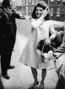 <p>Photographed visiting her sister in London, Jackie fixes her coif while wearing a windowpane-patterned coat and sleek black pumps.<br></p>