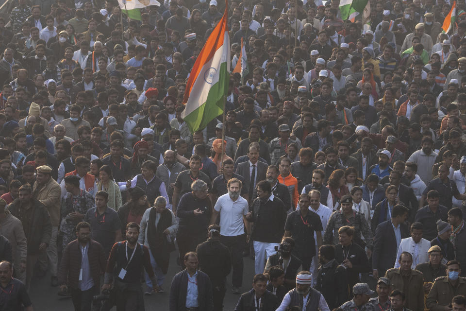 Rahul Gandhi, leader of India's opposition Congress party, centre in white T-shirt, walks with his supporters during a march, in New Delhi, India, Saturday, Dec. 24, 2022. Rahul Gandhi, leader of India's beleaguered opposition Congress party, on Saturday marched in New Delhi along with his supporters, part of his five-month-long 3,570km (2,218-mile) countrywide trek through 12 states that began 105 days ago.(AP Photo/Altaf Qadri)