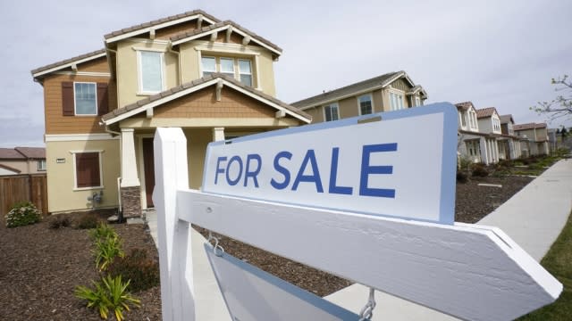 A "for sale" sign is posted in front of a home.