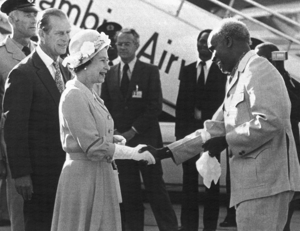 FILE - In this July 29, 1979 file photo, Zambia's President Kenneth Kaunda greets Britain's Queen Elizabeth II upon her arrival in Lusaka, Zambia on the final leg of her four-nation African tour. Zambia’s first president Kenneth Kaunda has died at the age of 97, the country's president Edward Lungu announced Thursday June 17, 2021. (AP Photo/File)