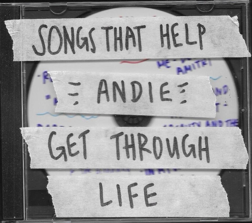 CD case labeled "Songs That Help Andie Get Through Life" using pieces of tape with handwritten text