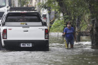 A resident negotiates a flooded road due to Typhoon Molave in Pampanga province, northern Philippines on Monday, Oct. 26, 2020. A fast moving typhoon has forced thousands of villagers to flee to safety in provinces. (AP Photo/Aaron Favila)
