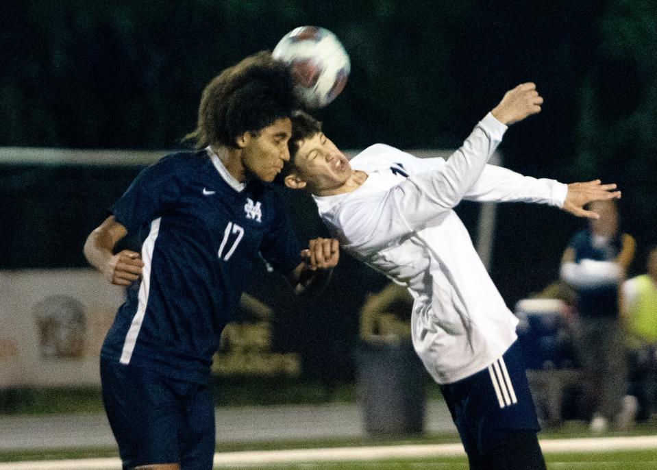 McKeel's Ahmad Kheder and Winter Haven's Anthony Castro head the ball on Friday night in the Premier bracket title game of the Polk County boys soccer tournament.