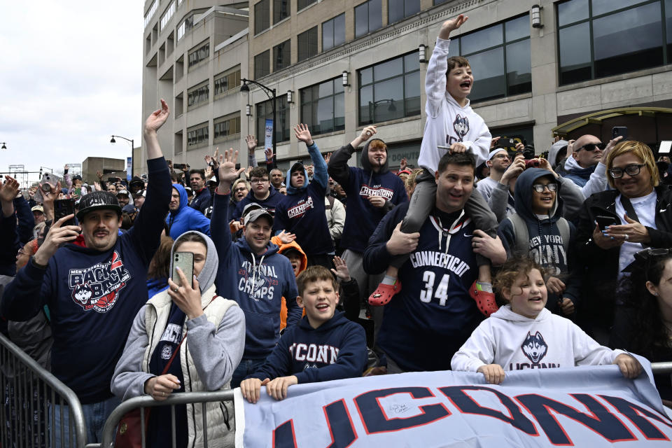 Fans react during a parade celebrating the UConn men's NCAA college basketball championship, Saturday, April 13, 2024, in Hartford, Conn. (AP Photo/Jessica Hill)