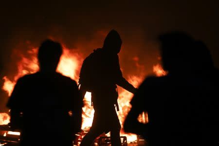 Barricades burn as protesters clash with riot police during the protests at the G20 summit in Hamburg. REUTERS/Hannibal Hanschke