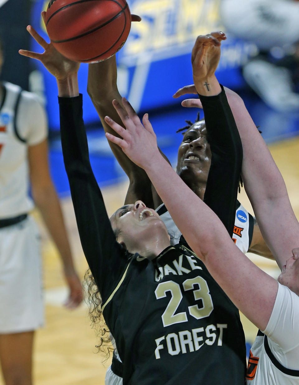 Oklahoma State forward Natasha Mack (4) blocks a shot attempt of Wake Forest forward Christina Mora during the first half of a college basketball game in the first round of the women's NCAA tournament at the Greehey Arena in San Antonio, Texas, Sunday, March 21, 2021. (AP Photo/Ronald Cortes)