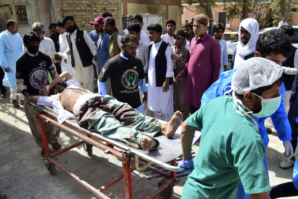 Paramedics and volunteers transport an injured victim of a bomb explosion upon arrival at a hospital, in Quetta, Pakistan, Friday, Sept. 29, 2023. A powerful bomb exploded at a rally celebrating the birthday of Islam's Prophet Muhammad in southwest Pakistan on Friday, killing multiple people and wounding dozens of others, police and a government official said. (AP Photo/Arshad Butt)