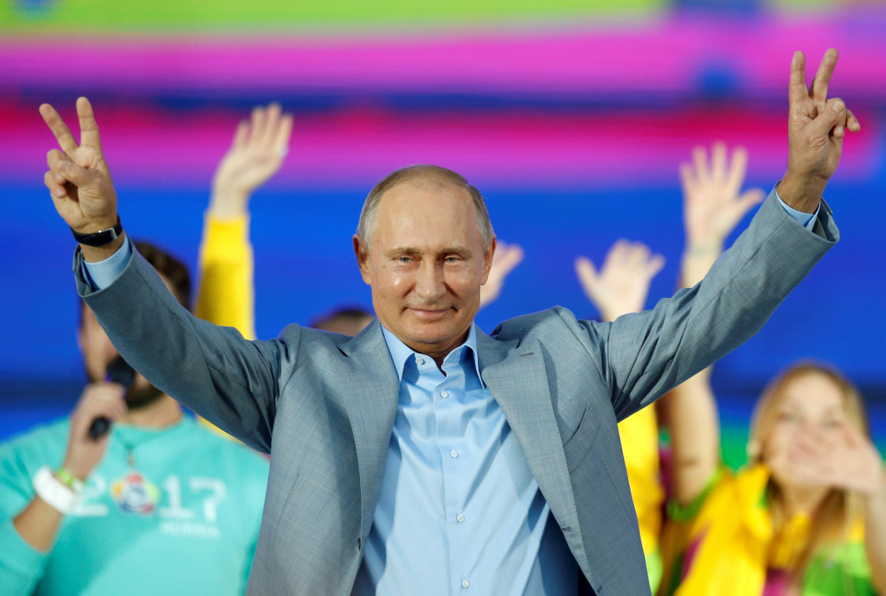 Russian President Vladimir Putin waves to participants of the 19th World Festival of Youth and Students Reuters