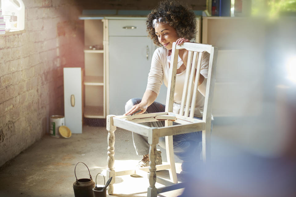 Woman working on an old wooden chair
