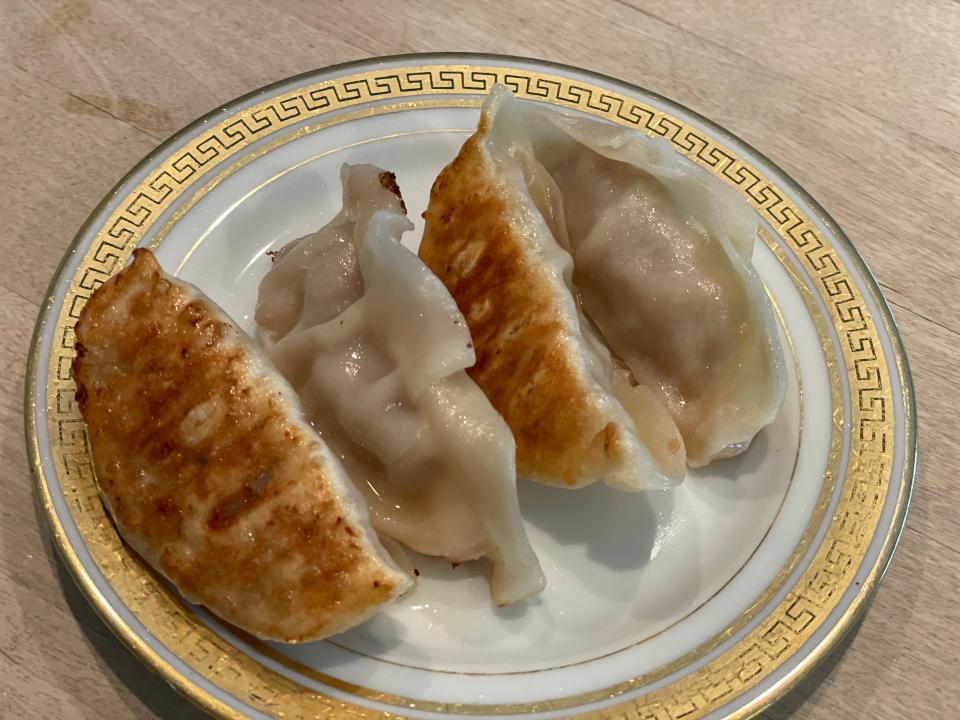 closeup shot of pan-fried potstickers on a plate