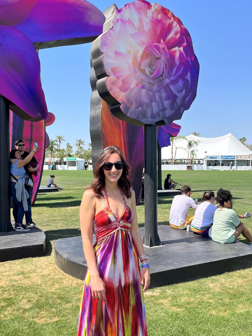 Artist Maggie West poses in front of her art installation "Eden" at the Coachella Valley Music and Arts Festival on April 14, 2023.