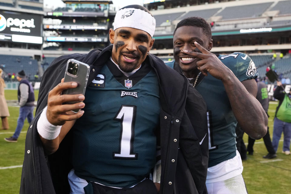 Philadelphia Eagles' Jalen Hurts, left, and Eagles' A.J. Brown pose as they leave the field after defeating the Tennessee Titans in an NFL football game, Sunday, Dec. 4, 2022, in Philadelphia. (AP Photo/Matt Rourke)