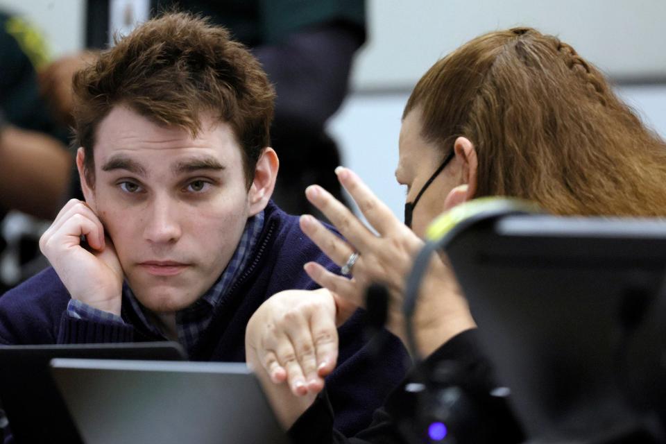 Marjory Stoneman Douglas High School shooter Nikolas Cruz speaks with paralegal Melissa Sly during a break in the penalty phase of Cruz’s trial at the Broward County Courthouse in Fort Lauderdale on Thursday, Sept. 1, 2022. Cruz previously plead guilty to all 17 counts of premeditated murder and 17 counts of attempted murder in the 2018 shootings.