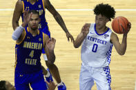 Kentucky's Jacob Toppin (0) looks for a teammate while defended by Morehead State's Johni Broome (4) during the second half of an NCAA college basketball game in Lexington, Ky., Wednesday, Nov. 25, 2020. Kentucky won 81-45. (AP Photo/James Crisp)