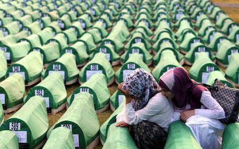 Bosnian Muslim women mourn over a casket during the funeral of 775 newly-identified Bosnian Muslims at the Potocari Memorial Center in Srebrenica in 2010. - Credit: Fehim Demir&nbsp;/Rex