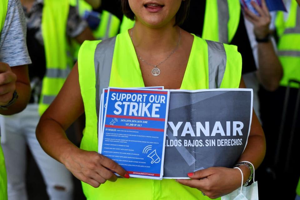 A Ryanair employee holds flyers as they protest at Barcelona airport on July 1 (AFP via Getty Images)