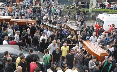 Relatives and friends of the Safwan family, that drowned on a boat carrying them from Turkey to Greece, carry their coffins during their funeral in Beirut's southern suburb of Ouzai, Lebanon October 22, 2015. REUTERS/Mohamed Azakir