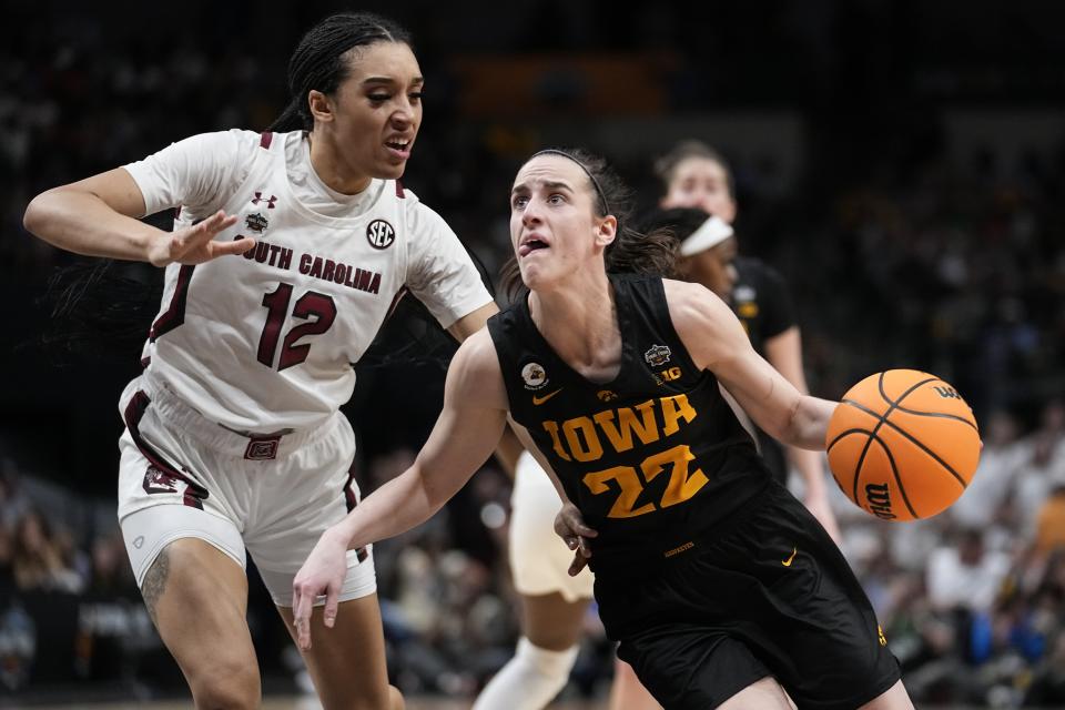 Iowa's Caitlin Clark drives past South Carolina's Brea Beal during the second half of an NCAA Women's Final Four semifinals basketball game Friday, March 31, 2023, in Dallas. (AP Photo/Tony Gutierrez)