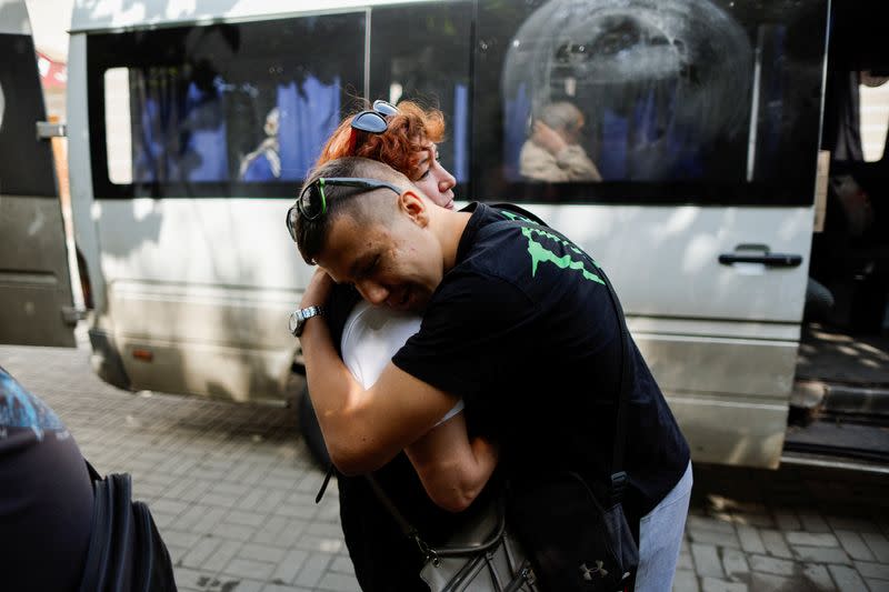 FILE PHOTO: Son hugs his mom, during the evacuation from war-affected areas in eastern Ukraine, in Bakhmut