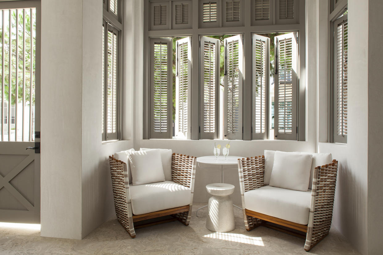  A living room with curtains replaced by shutters 