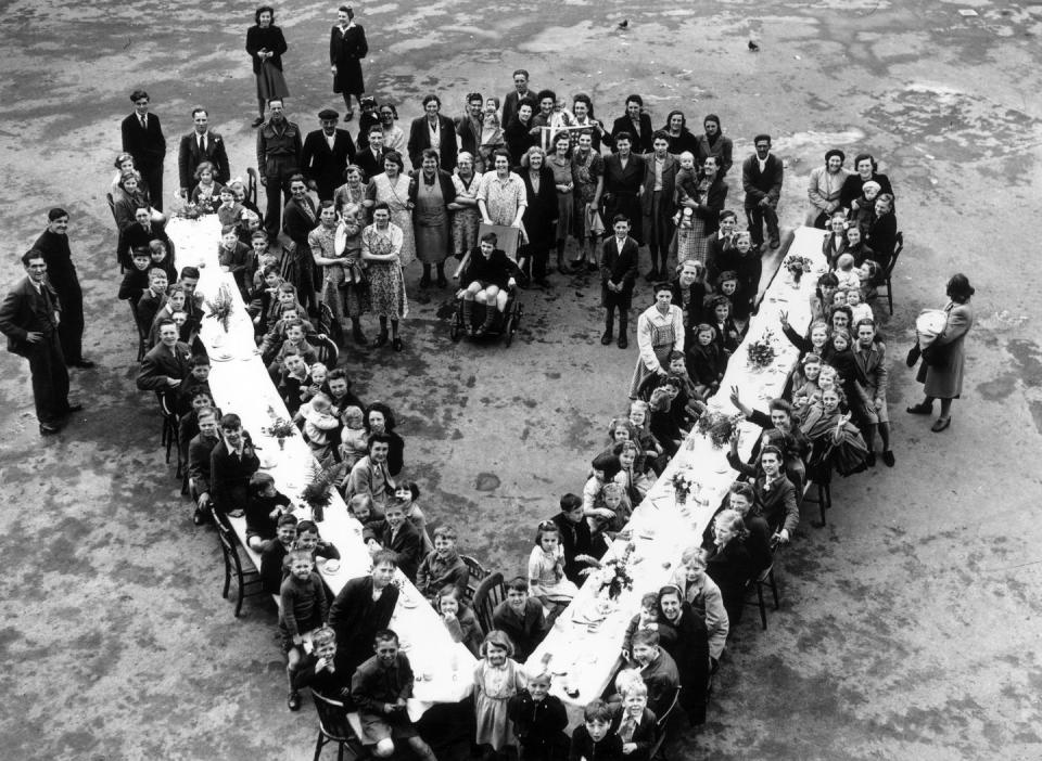 <p>Residents in South London get creative with the table arrangement for their V-E Day celebration. </p>