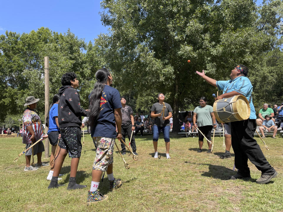 Choctaw teenagers demonstrate stickball at the 30th annual Ocmulgee Indigenous Celebration on Saturday, Sept. 17, 2022 in Macon, Ga. The game traditionally involved up to hundreds of players at a time, and was used as an alternative to war for settling disputes. (AP Photo/Michael Warren)