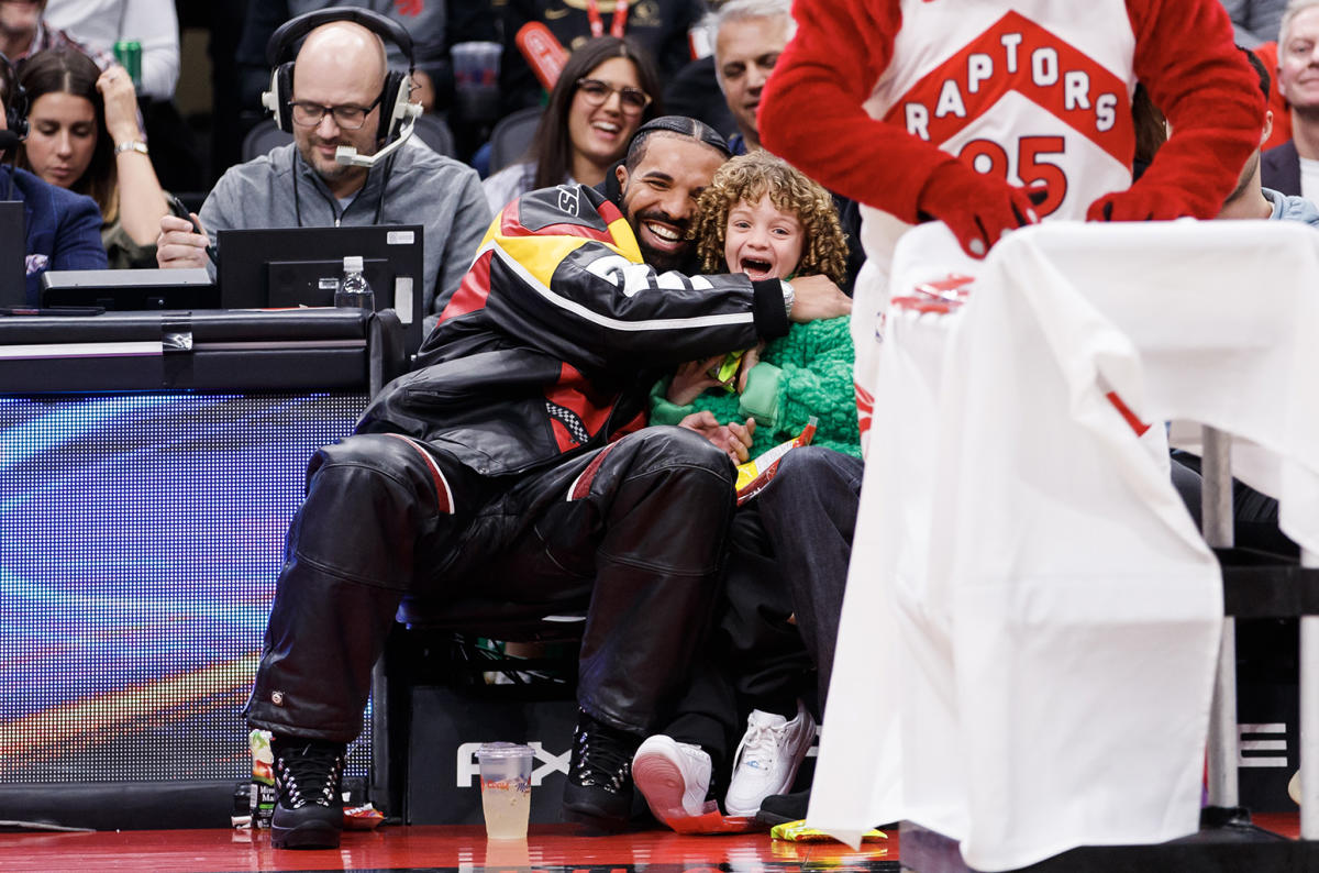 Drake and son Adonis, 5, match in leather jackets at basketball game