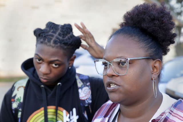 <p>Michael Wyke/AP Photo</p> Darryl George, left, a 17-year-old junior, and his mother Darresha George, right, talks with reporters before walking across the street to go into Barbers Hill High School after Darryl served a 5-day in-school suspension for not cutting his hair, Sept. 18, 2023, in Mont Belvieu, Texas.