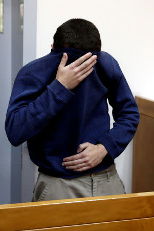FILE PHOTO: An U.S.-Israeli teen who was arrested in Israel on suspicion of making bomb threats against Jewish community centres in the United States, Australia and New Zealand over the past three month, is seen before the start of a remand hearing at Magistrate's Court in Rishon Lezion, Israel March 23, 2017. REUTERS/Baz Ratner/File Photo