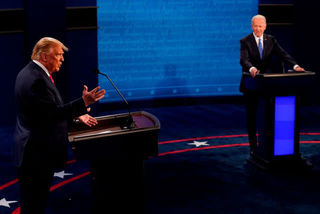 <p>MORRY GASH/POOL/AFP via Getty</p> Donald Trump and Joe Biden debate at Belmont University in Nashville, Tennessee, on October 22, 2020