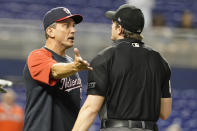 Washington Nationals bench coach Tim Bogar, left, argues a call with home plate umpire Adam Beck during the 10th inning of a baseball game against the Miami Marlins, Monday, Sept. 20, 2021, in Miami. (AP Photo/Marta Lavandier)