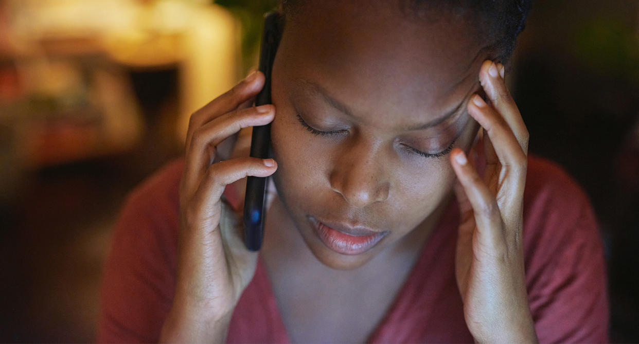 Picture of a woman on the phone to represent calling the police about domestic abuse. (Getty Images)