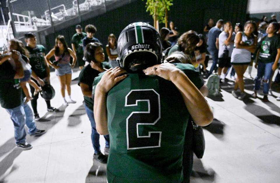 Family, friends and supporters gather and take turns hugging Reedley’s Malachi Rios after the game against Roosevelt Friday night, Aug. 25, 2023 in Reedley. Rios will be undergoing chemotherapy for the second time after this game.