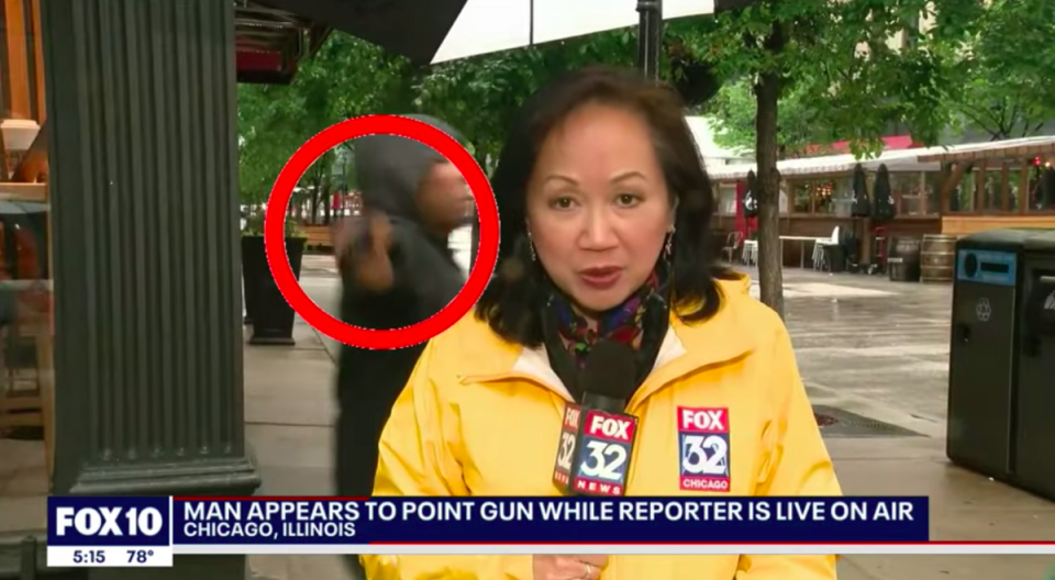 The moment a man appeared to pull a gun in front of a Fox News TV crew is caught on camera. (Fox News 10 Phoenix/screengrab)