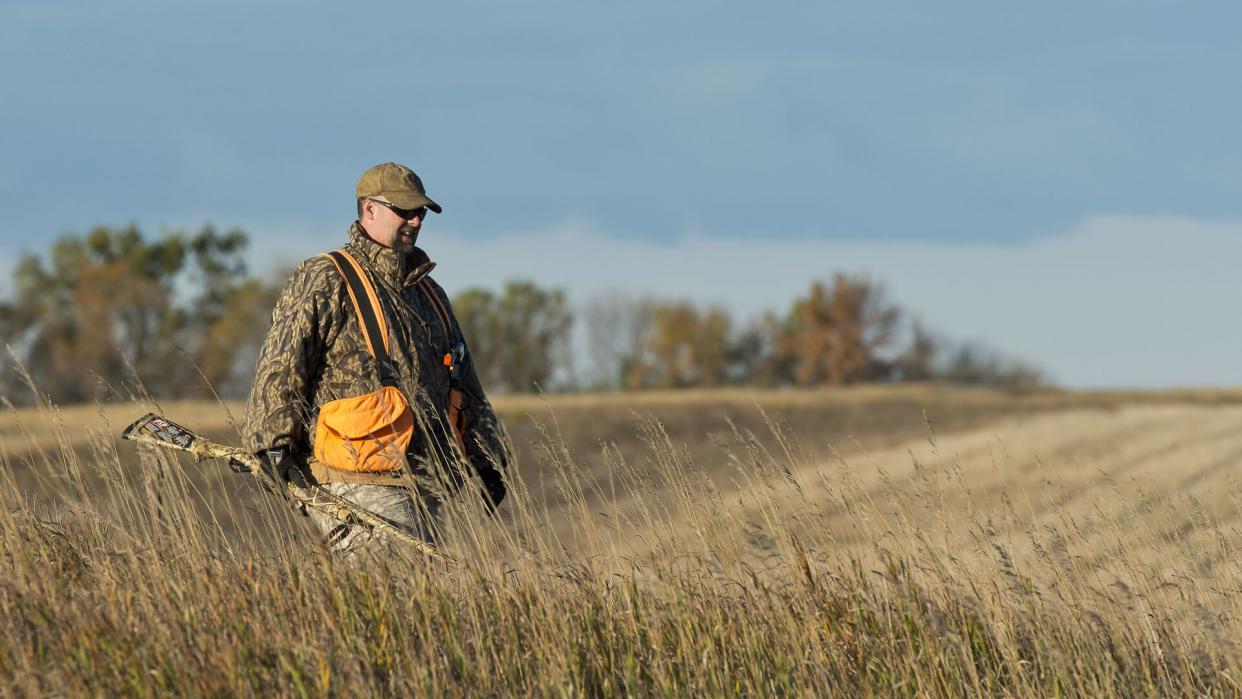 hunter walking in field in Nebraska