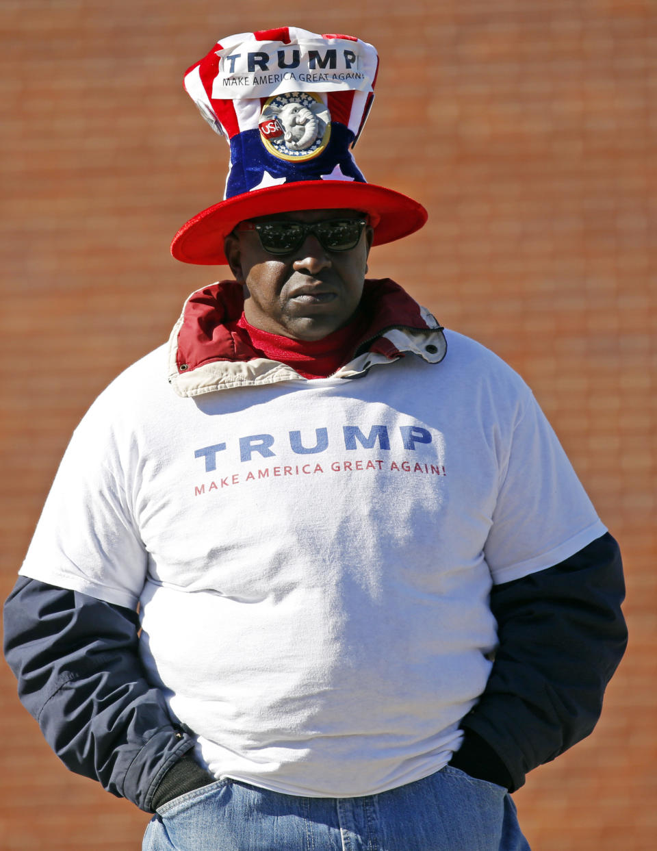 <p>A Trump supporter wears a campaign hat as he observes the grand opening ceremony for the two museums, the Museum of Mississippi History and the Mississippi Civil Rights Museum, Saturday, Dec. 9, 2017, in Jackson, Miss. (Photo: Rogelio V. Solis/AP) </p>