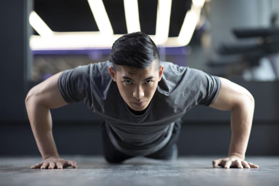 young man exercising at gym