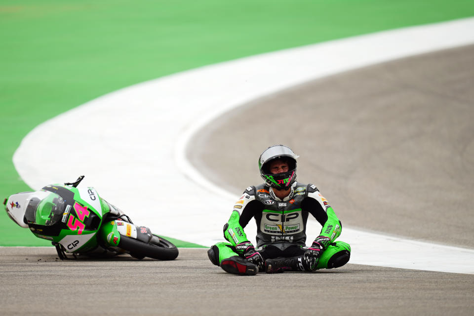 Moto3 rider Riccardo Rossi of Italy reacts after crashing during the Portuguese Motorcycle Grand Prix at the Algarve International circuit near Portimao, Portugal, Sunday, March 24, 2024. (AP Photo/Jose Breton)