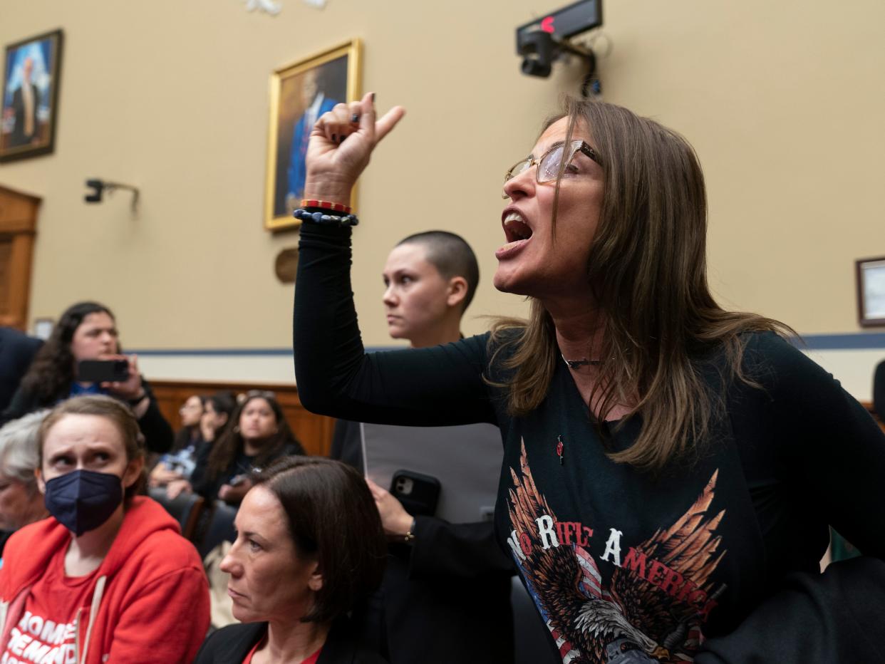 Patricia Oliver, the mother of Joaquin Oliver, one of the victims of the 2018 mass shooting at Marjory Stoneman Douglas High School in Parkland, Fla., is argues with lawmakers during a hearing recess on Capitol Hill in Washington, Thursday, March 23, 2023.