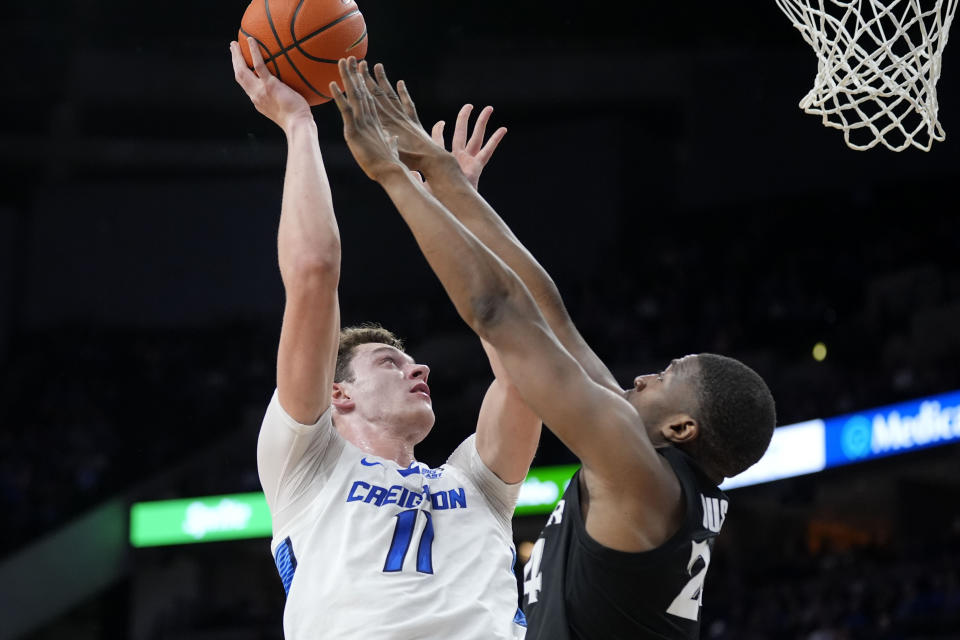 Creighton center Ryan Kalkbrenner (11) is fouled by Xavier forward Abou Ousmane (24) during the first half of an NCAA college basketball game, Tuesday, Jan. 23, 2024, in Omaha, Neb. (AP Photo/Charlie Neibergall)