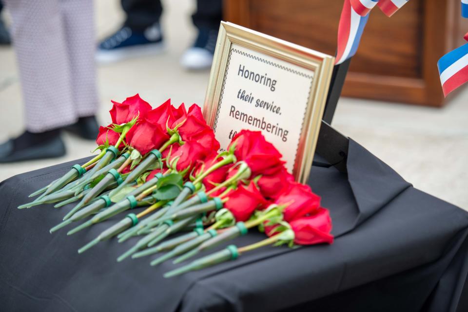 Roses in honor of Madison County officers killed in the line of duty stacks on a table during the National Law Enforcement Memorial Service at Madison County Sheriff's Office in Denmark, Tenn. on Friday, May 19, 2023. 