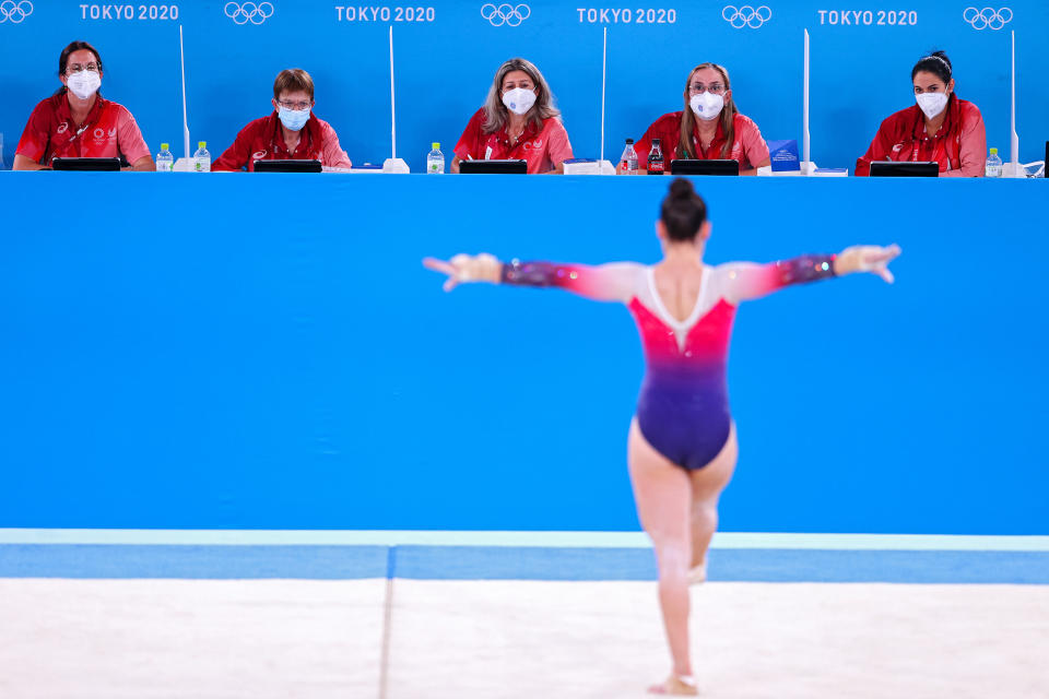 <p>Judges wearing masks due to the Covid-19 pandemic look on as an athlete trains in the floor exercise during Women's Podium Training ahead of the Tokyo 2020 Olympic Games at Ariake Gymnastics Center on July 22, 2021 in Tokyo, Japan. (Photo by Patrick Smith / Getty Images)</p> 