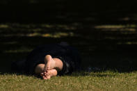 <p>A man lies in the shade in St James Park, London, Tuesday, Aug. 23, 2016, as parts of the country prepare for hot weather with temperatures reaching up to 29 degrees Centigrade (84 Fahrenheit). (Dominic Lipinski/PA via AP) </p>